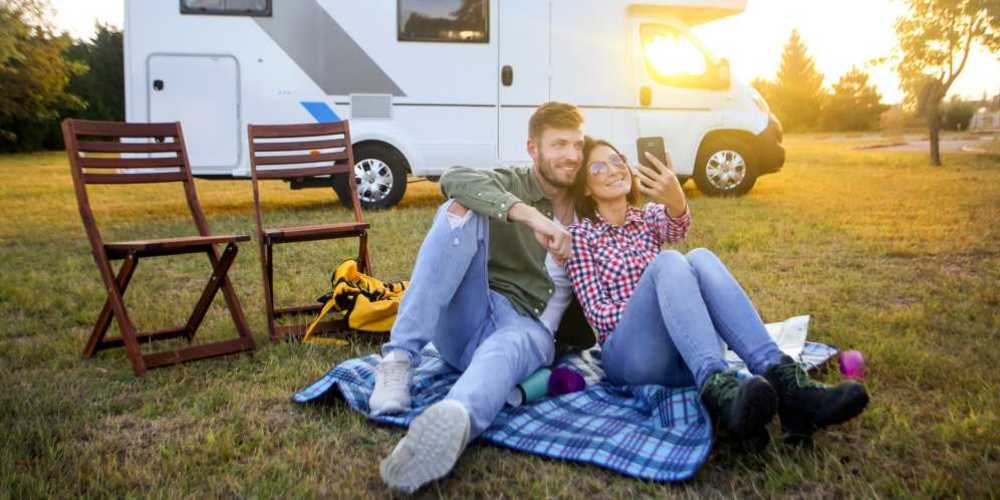Resident couple relaxing near their RV in a park at Eugene RV and Boat Storage in Eugene, Oregon