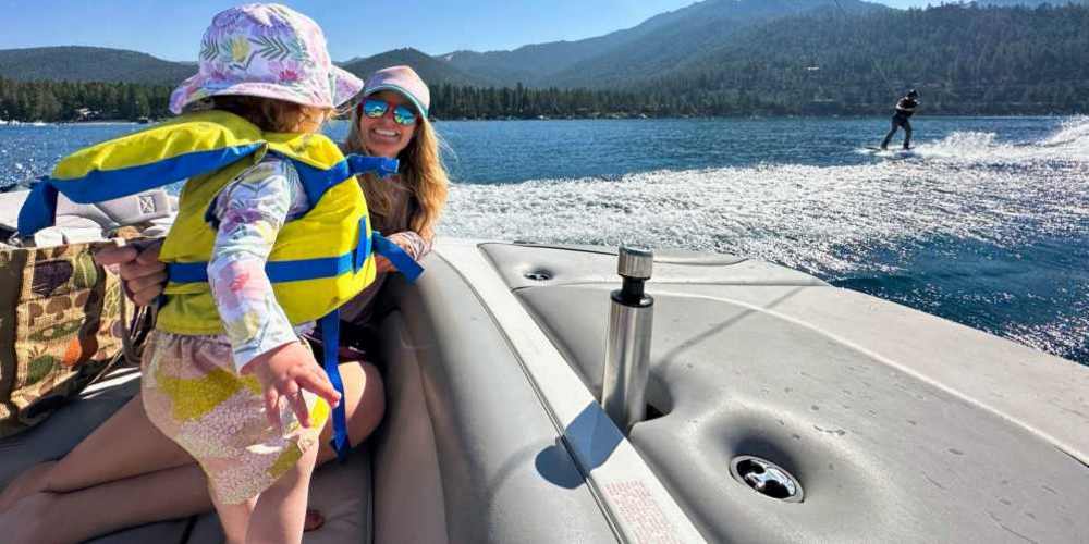 Resident woman relaxing in a boat with her daughter at Eugene RV and Boat Storage in Eugene, Oregon