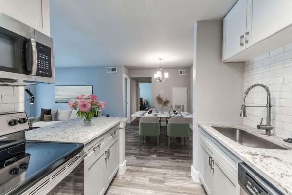 Kitchen with access to dining area at The Brighton in Houston, Texas