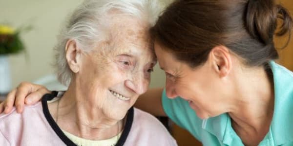 Resident and a smiling caregiver at Montello Care Center in Montello, Wisconsin