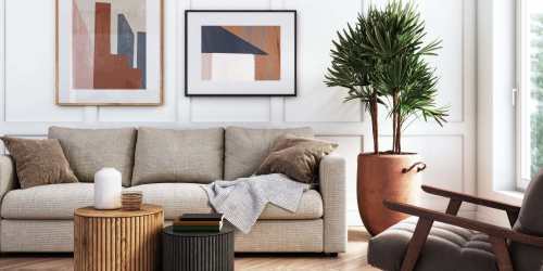Living room with a couch, small coffee table and wall paintings at Comanche Hills in La Mesa, California