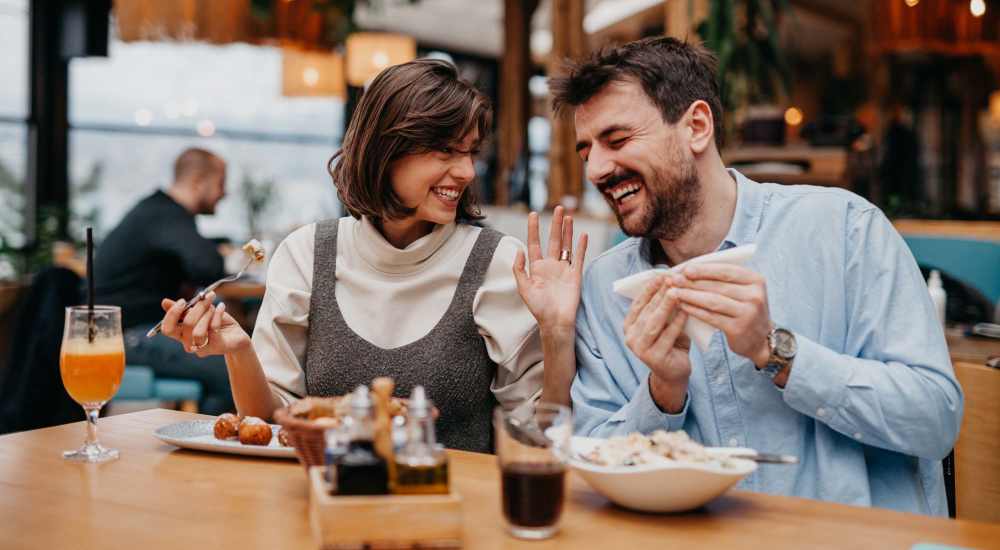 Couple enjoying their favorite food in local restaurant near The Lofts at 305 in Bryan, Texas