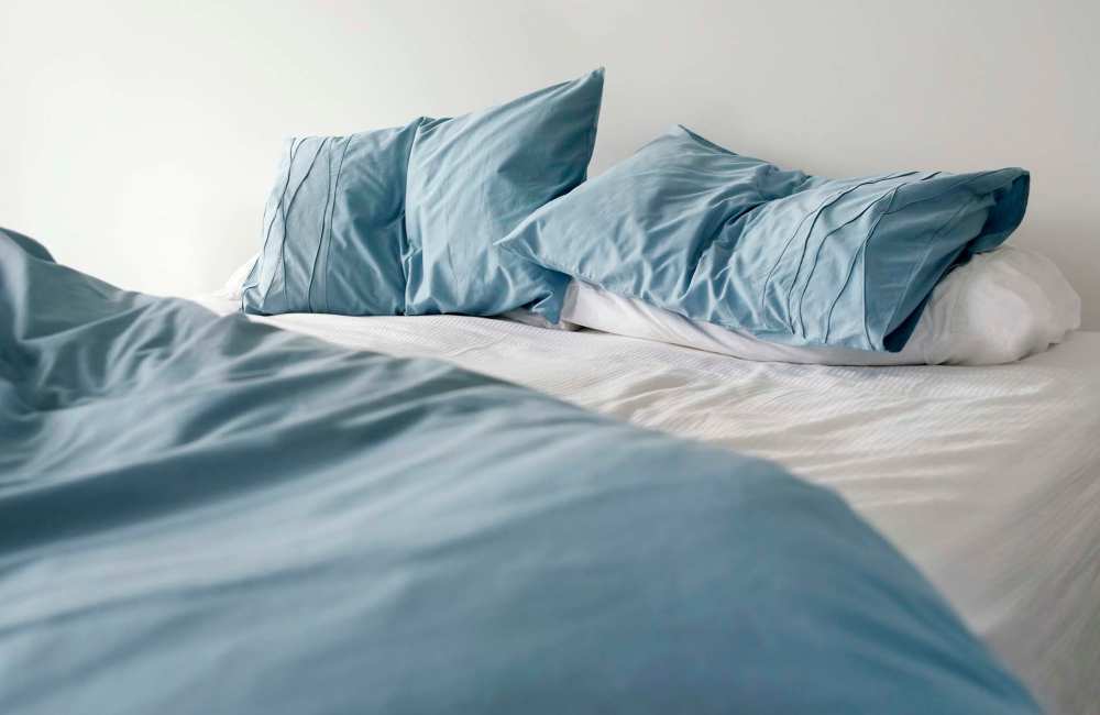 Bedroom with blue pillows at Winchester Run in Oklahoma City, Oklahoma