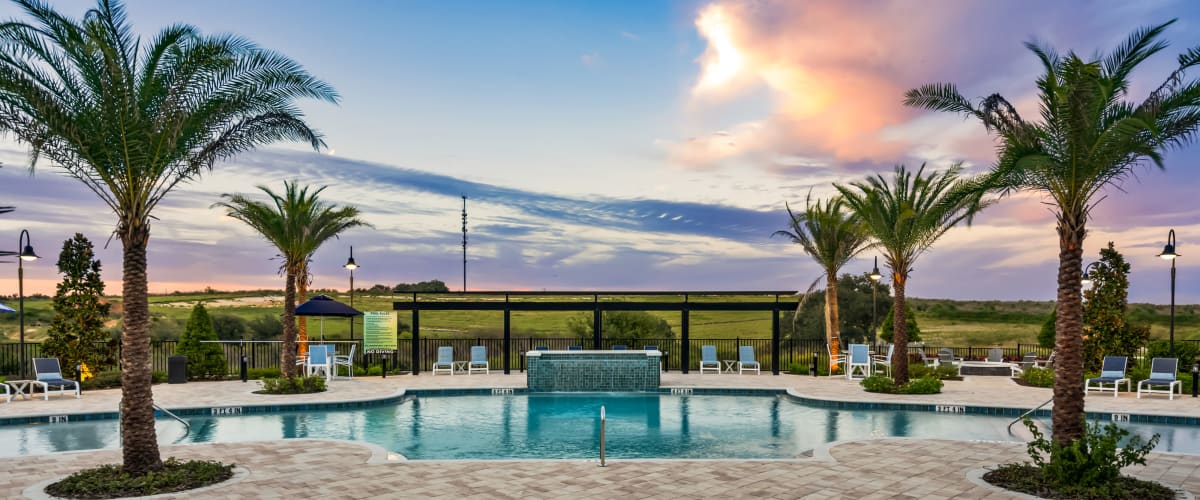 The community pool and surrounding seating at Integra Heights in Clermont, Florida