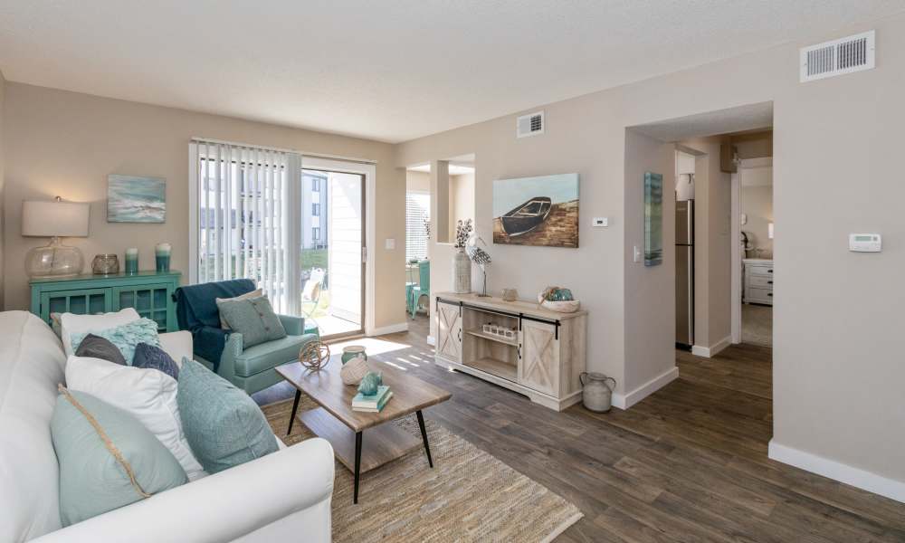 Living room with vinyl plank floors with sliding door to patio
