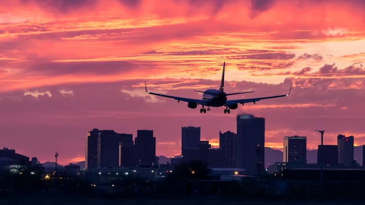 An airplane landing at sunset in Phoenix, Arizona