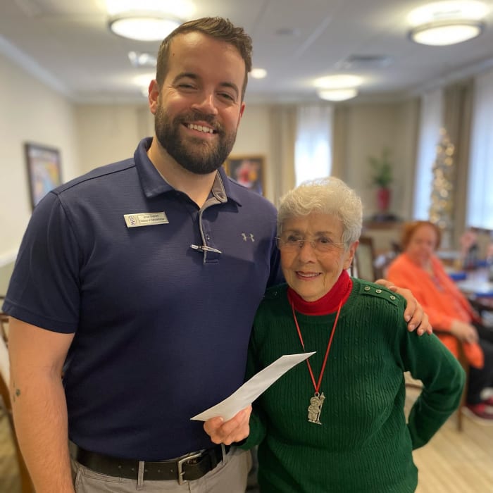 Resident standing next to a tall caretaker at The Florence Presbyterian Community in Florence, South Carolina