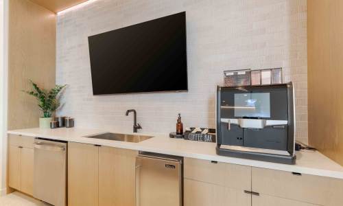 Community kitchen with coffee maker at Tempo at Nine Mile Station in Aurora, Colorado