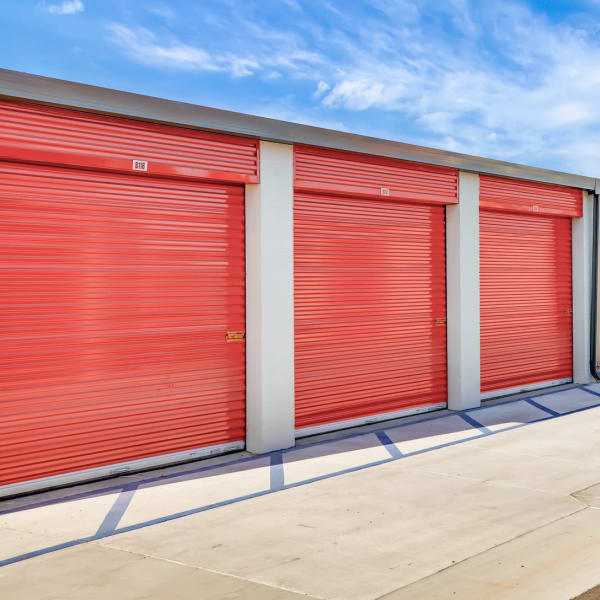 Drive-up access storage units with red doors at StorQuest Self Storage in Tampa, Florida