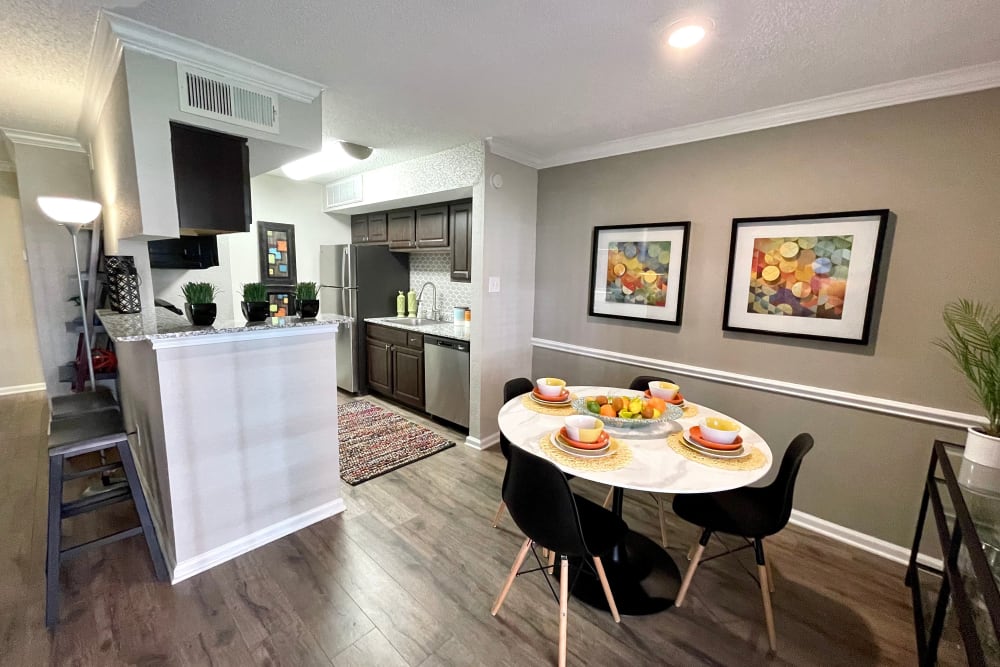 Dining nook and kitchen in a apartment at The Abbey at Montgomery Park in Conroe, Texas