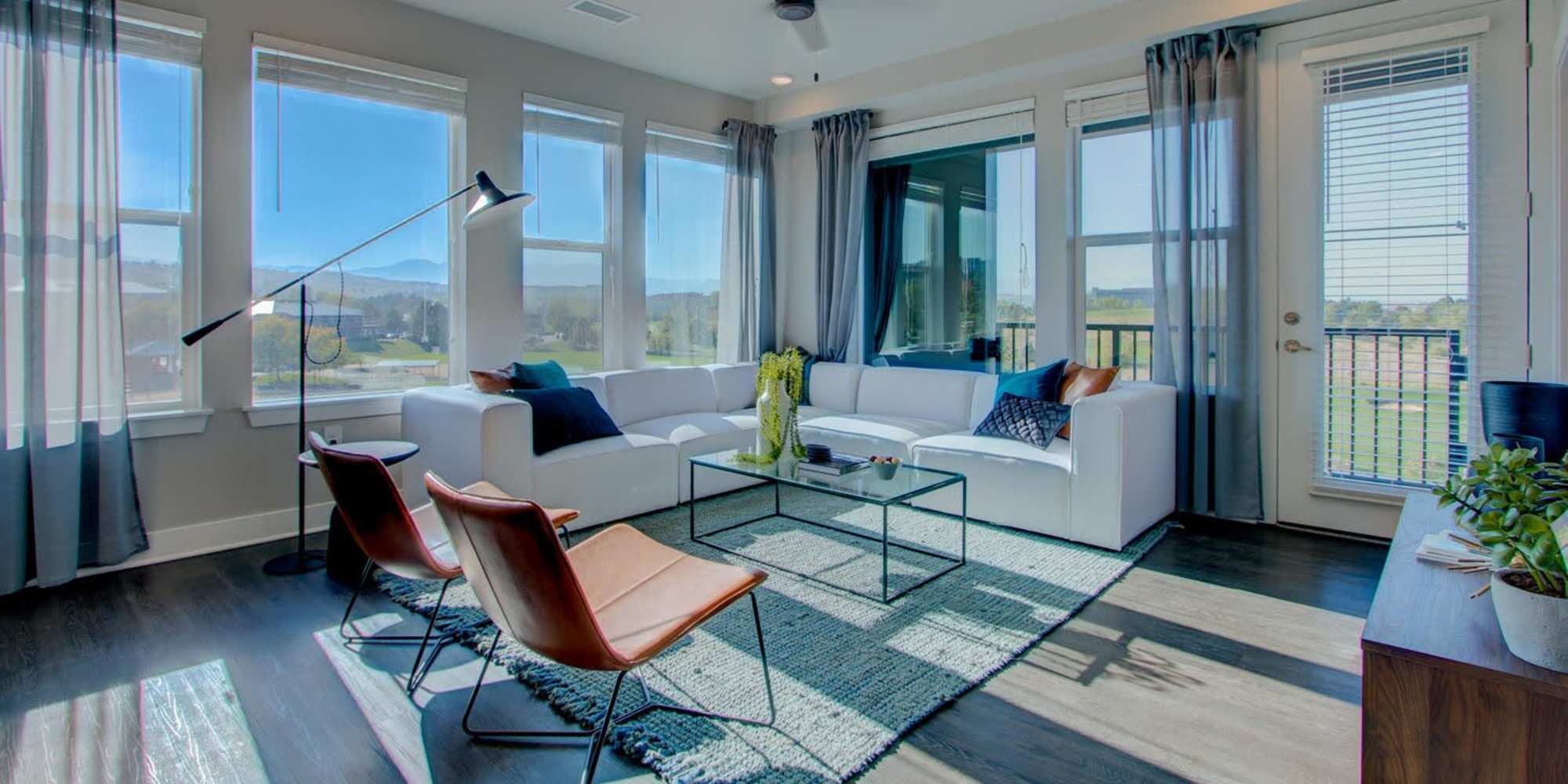 Living room with lots of windows at Fusion 355 in Broomfield, Colorado