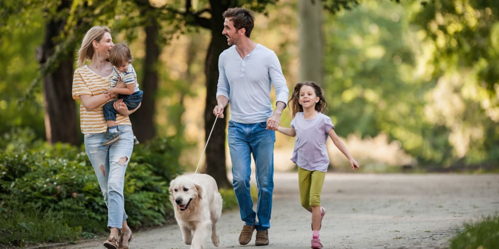 A happy family out walking their dog near The Baldwin in Orlando, Florida