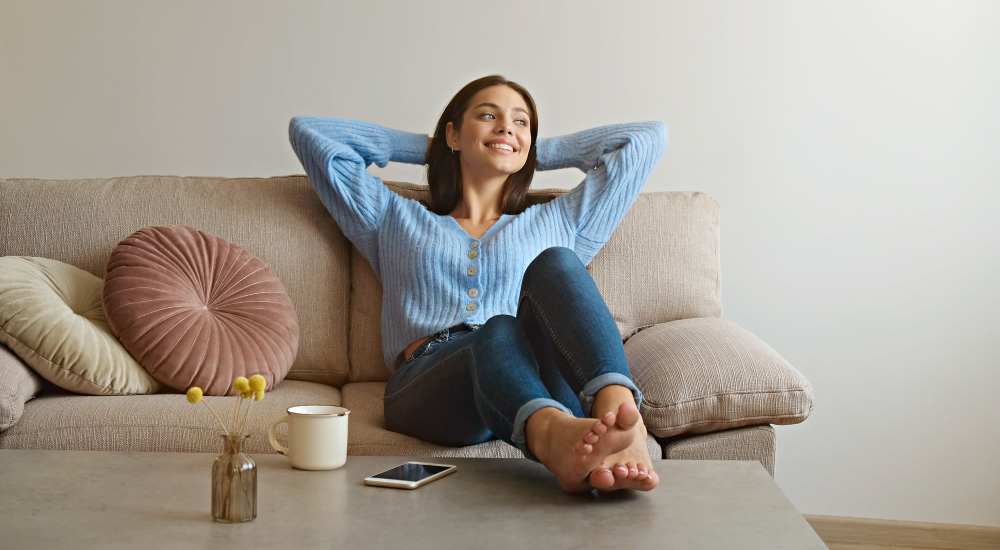Resident relaxing in her living room at Fayette Arms Apartments in Mountain View, California
