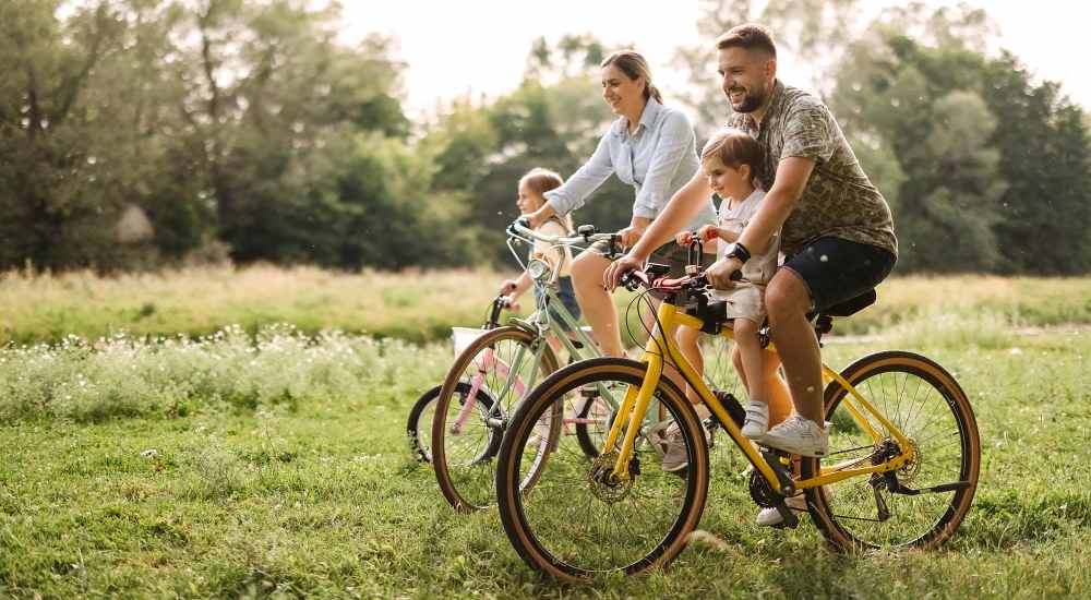 Resident family cycling at a park near The Millwright in Cornelius, North Carolina