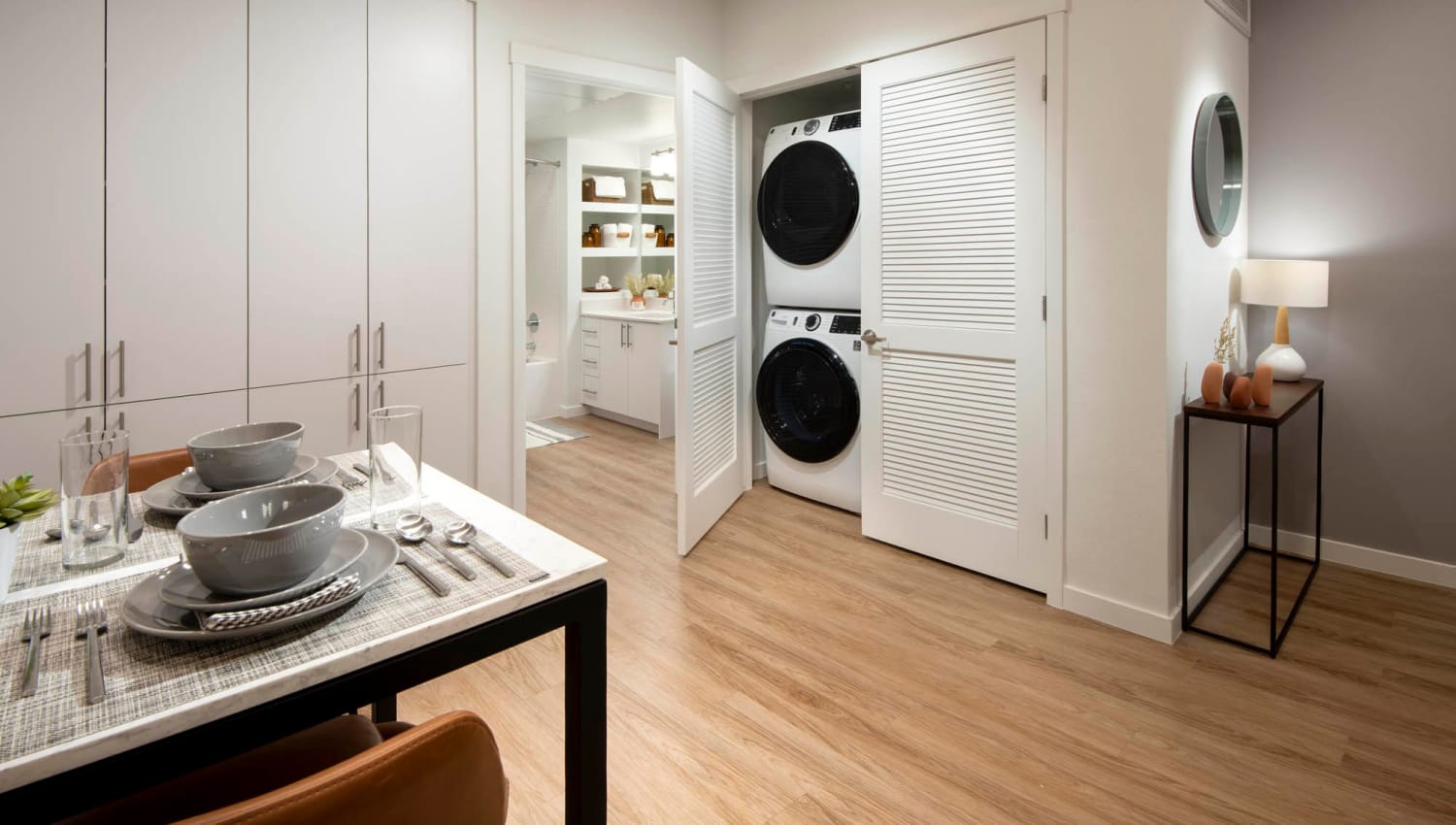 Kitchen with the laundry closet doors open at Aiya in Gilbert, Arizona