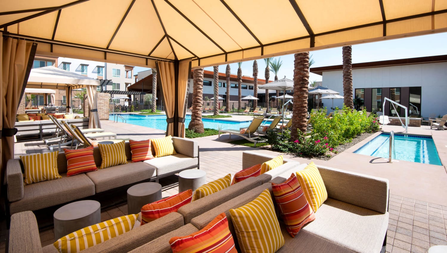Covered outdoor lounge by the pool at Aiya in Gilbert, Arizona