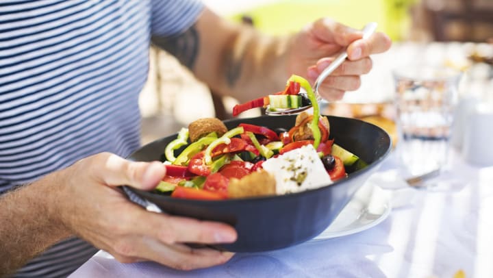 Man eating Greek salad