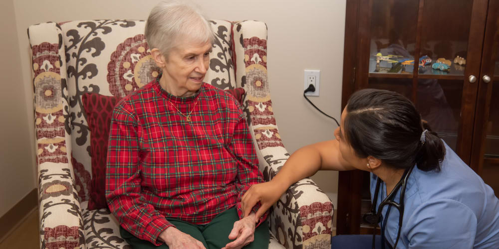 A nurse taking a patient's pulse at Careage Home Health in Dupont, Washington. 