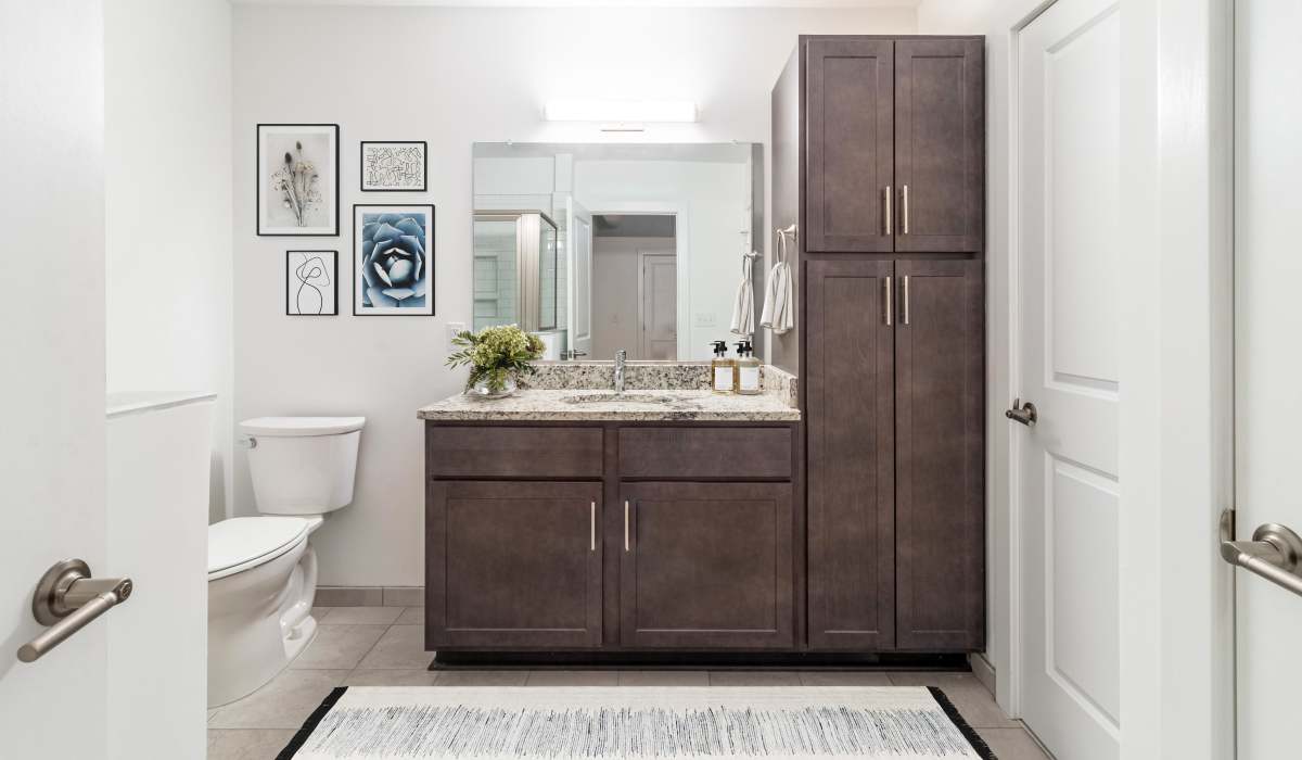 Tile backsplash in an apartment bathrooms shower with glass doors at Landmark at Marshall Broad in Richmond, Virginia