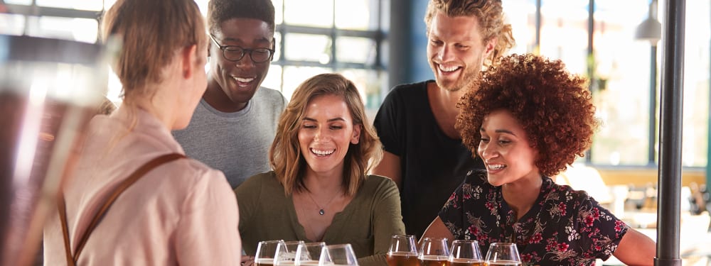 Friends gathered for a beer flight at a brewery near Harborside Marina Bay Apartments in Marina del Rey, California