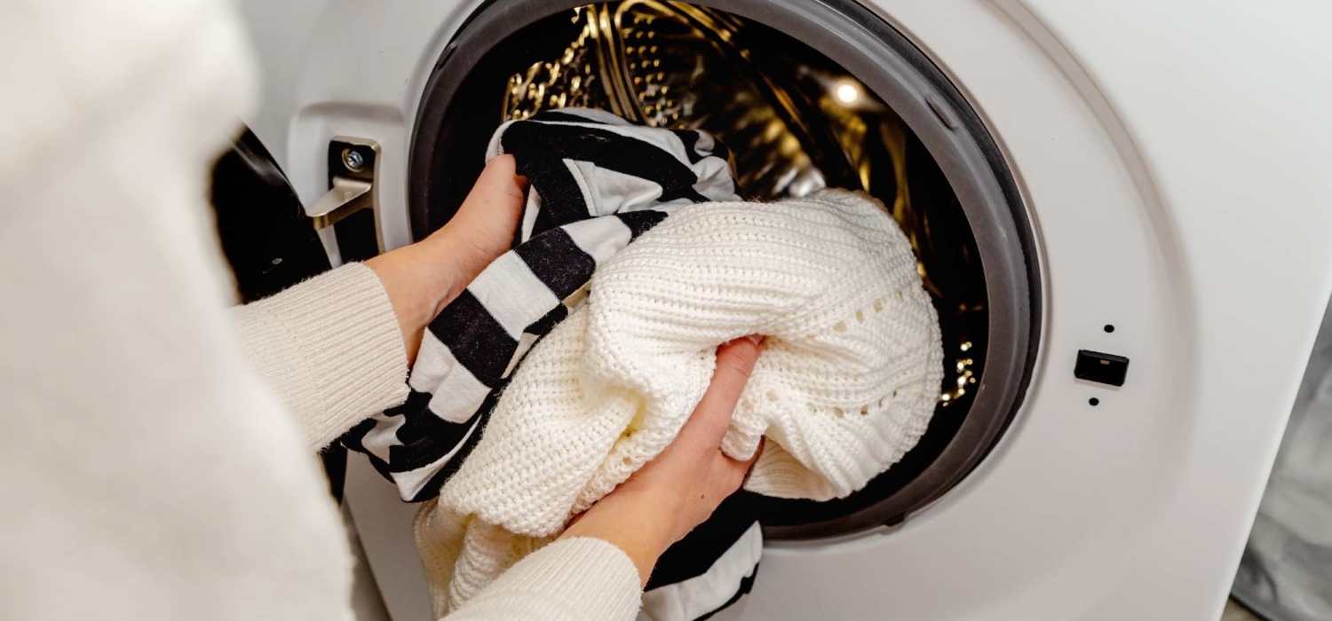 Women loading clothes into the washer at East Bend Trace in Greenville, North Carolina