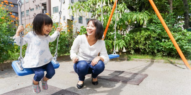 A resident and her child at a school playground near Chollas Heights in San Diego, California