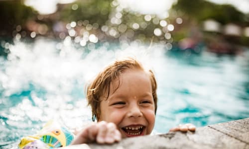 Kid playing in the pool at Washington Townhomes in San Lorenzo, California