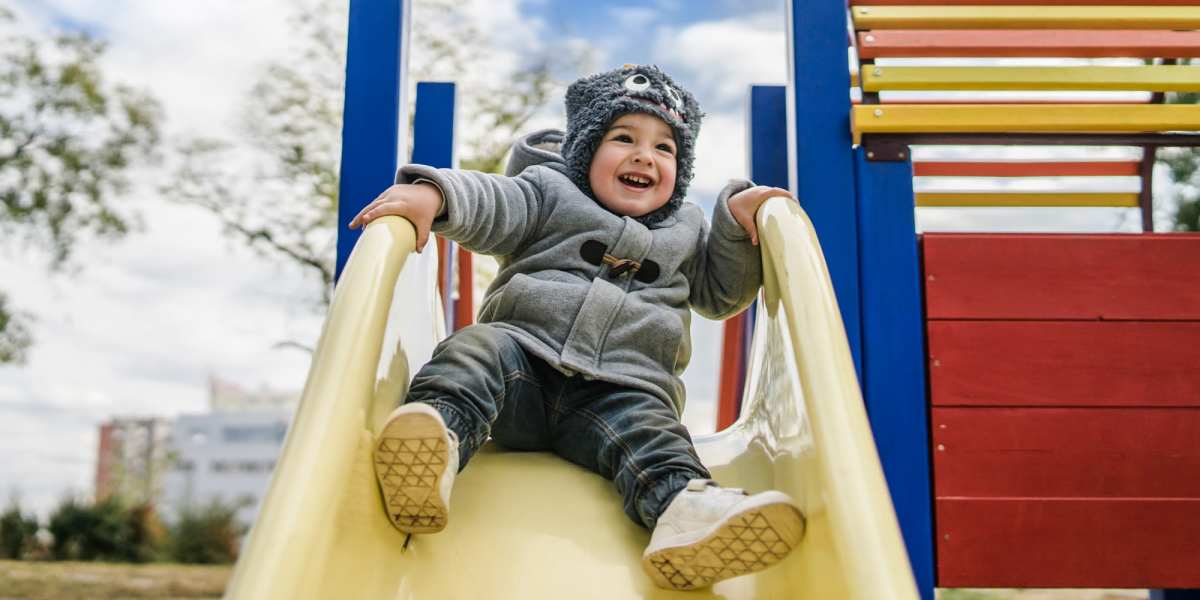 Child playing on a slide at the playground at Landings at East Pointe in Fort Myers, Florida