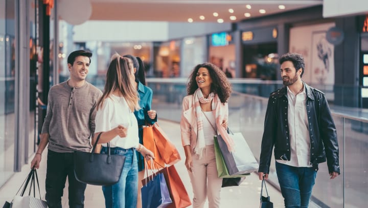 A group of friends walking through a shopping mall
