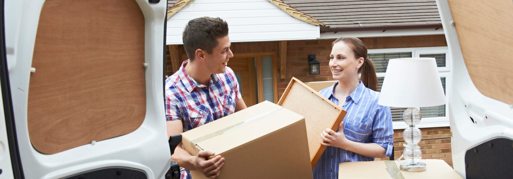 Couple moving boxes to Self Storage Plus in Baltimore, Maryland