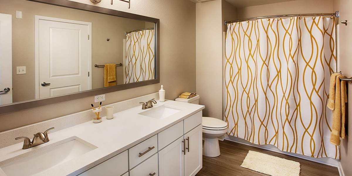 Bathroom with white cabinets at The Greens at Van de Water in Loveland, Colorado