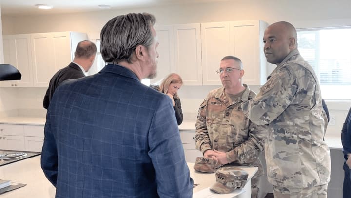 Lt. Gen. Kevin Vereen, right, deputy chief of staff, Army G-9, gets a briefing along with a walk-through tour with of one of the base houses during his visit to Joint Base Lewis-McChord April 3. Pictured left, Kevin Clarke, Senior Vice President of Construction and Environmental Services.