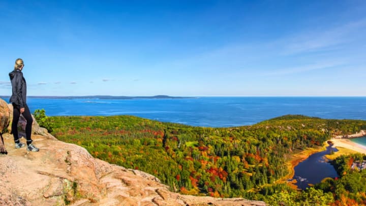 Hiker enjoying the top of a hike in Acadia