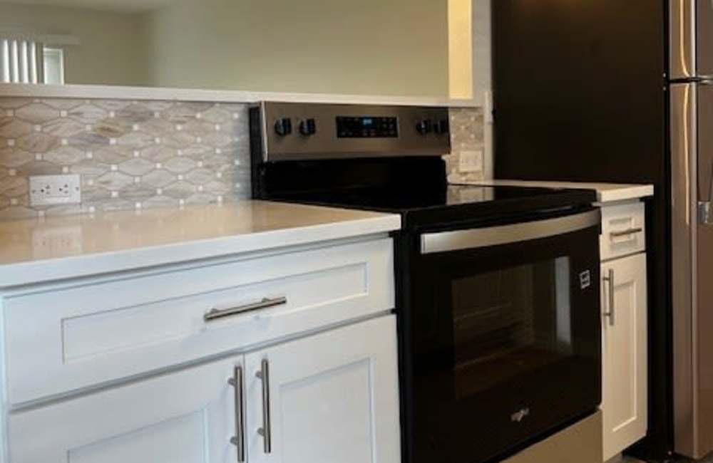 Kitchen with white cabinets at Bayside Villas Apartment Homes in South Pasadena,Florida