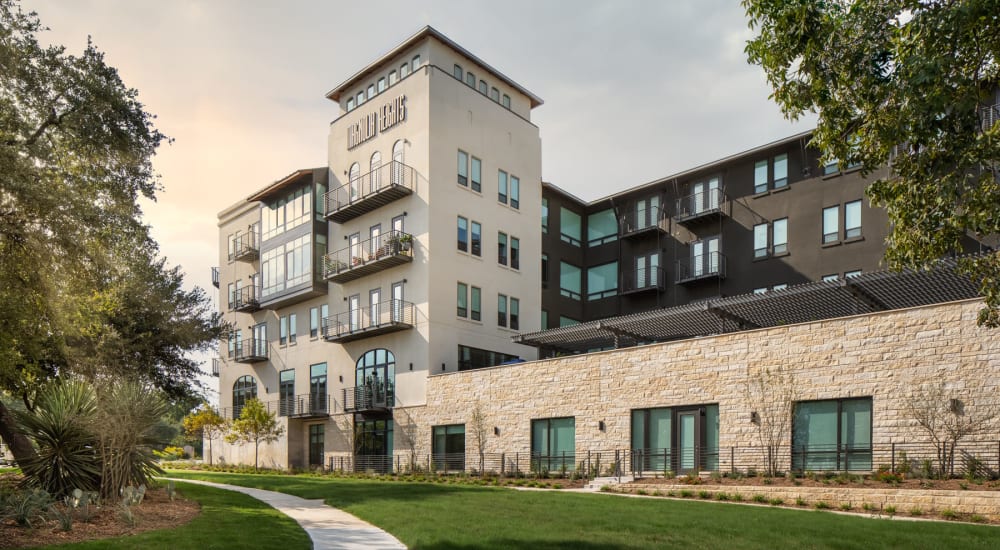Exterior view of the leasing center with professionally maintained urban landscaping at Magnolia Heights in San Antonio, Texas