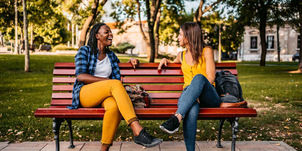 Residents sitting in a bench at a park near The Oliver in Charlotte, North Carolina