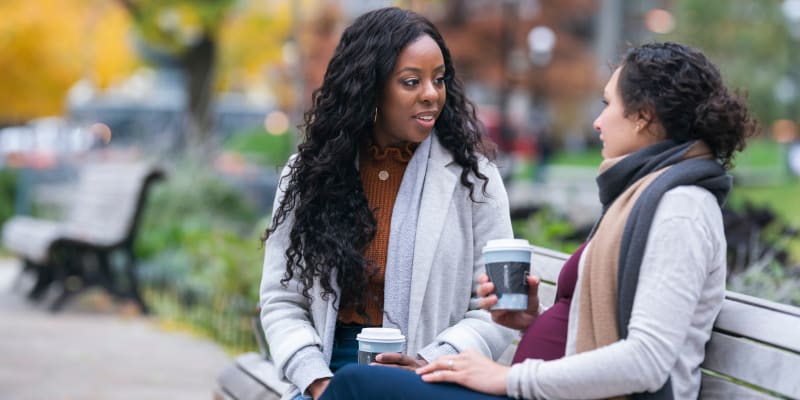 Residents drinking coffee on a park bench near Olde Forge Townhomes in Perry Hall, Maryland