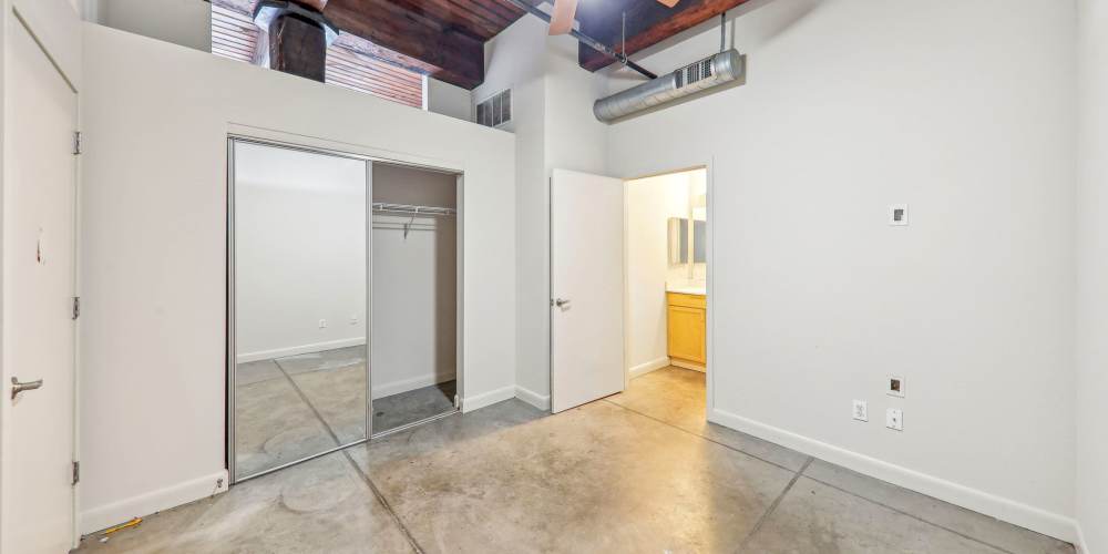 Unfurnished bedroom with attached bathroom at Stadium Loft Apartments in Saint Louis, Missouri