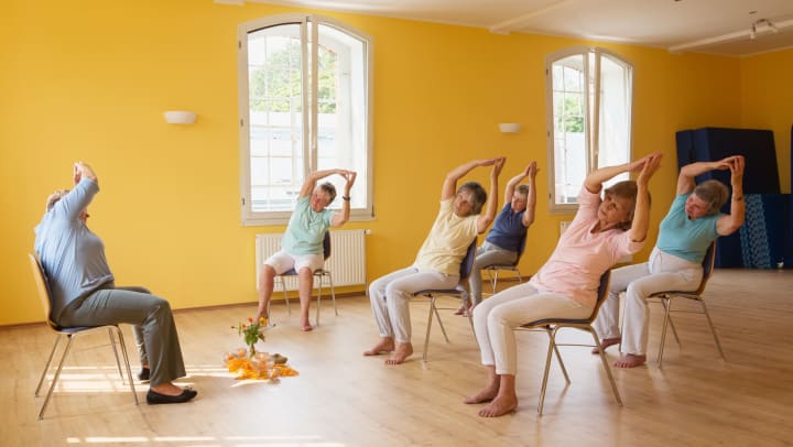 Senior women in a chair yoga class at Brightwater Senior Living of Tuxedo in Winnipeg, Manitoba