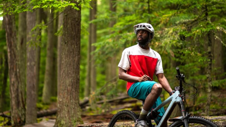 A man on a mountain bike in the middle of a forest. 