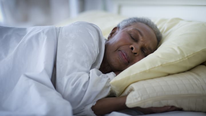 Senior woman sleeping in a bed