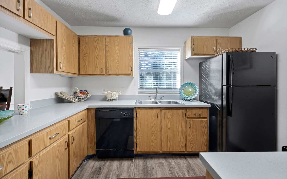 Modern kitchen with black appliances  at Carlton Arms Of South Lakeland in Lakeland, Florida