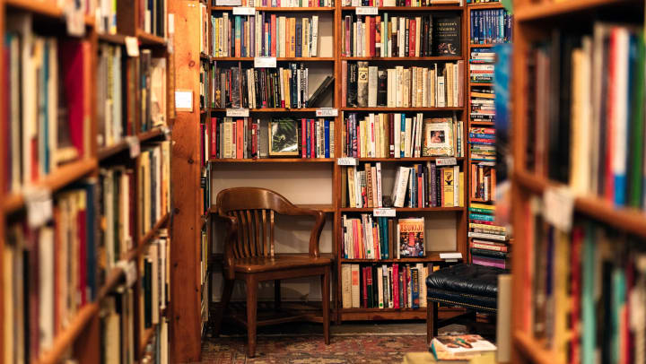 A corner of a bookstore surrounded by shelves filled to the brim with books | bookstores in Las Cruces