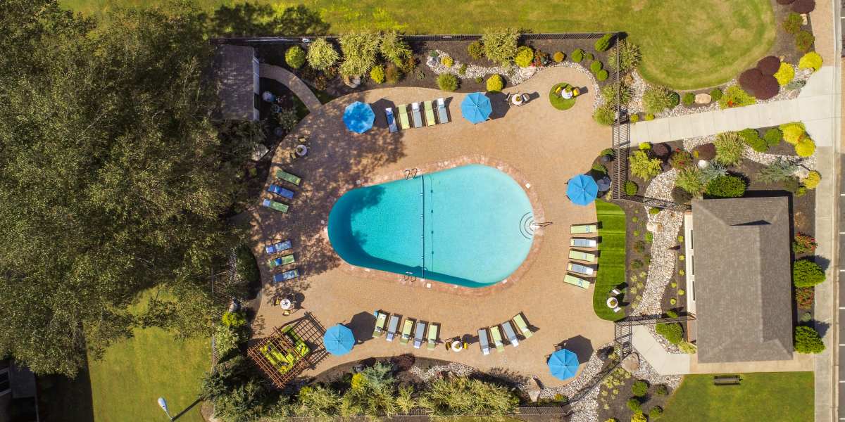 Swimming pool surrounded by lounge chairs at Collins Crossing Apartments in Carrboro, North Carolina 