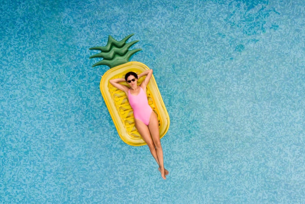Relaxing on a pineapple floaty in the pool at Cherokee Summit Apartments in Acworth, Georgia