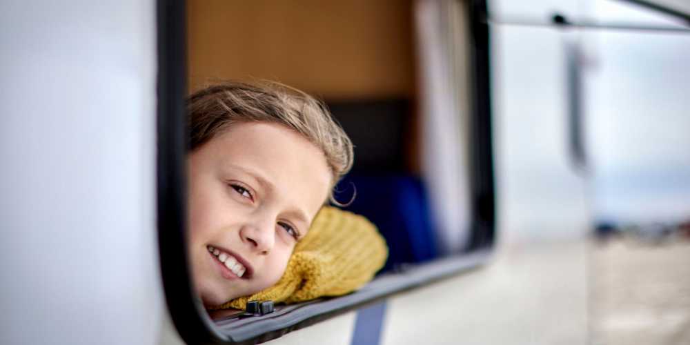 A kid looking through the window of an RV from Stayton Mini Storage in Stayton, Oregon
