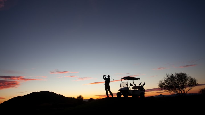Golfer teeing off at sunrise near Vistara at SanTan Village in Gilbert, Arizona