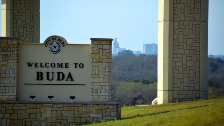 Monument sign welcoming all to our city near Carrington Oaks in Buda, Texas