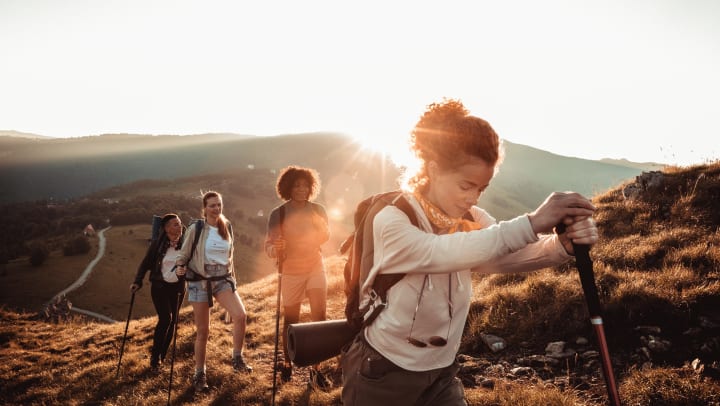 Four woman hiking up a mountain