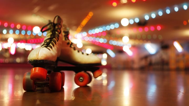 Roller skates under the lights of the roller disco.